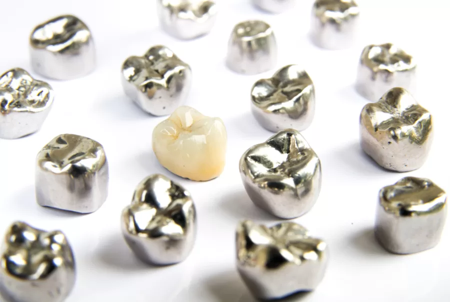Ceramic Dental Crown surrounded by Metal Crowns