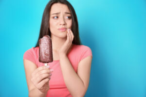 woman with sensitive teeth after biting ice cream