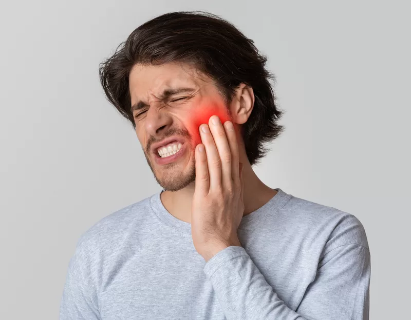 Person experiencing bad tooth pain