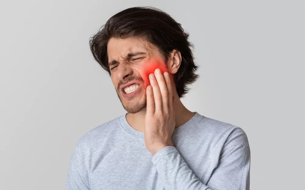 Person experiencing bad tooth pain